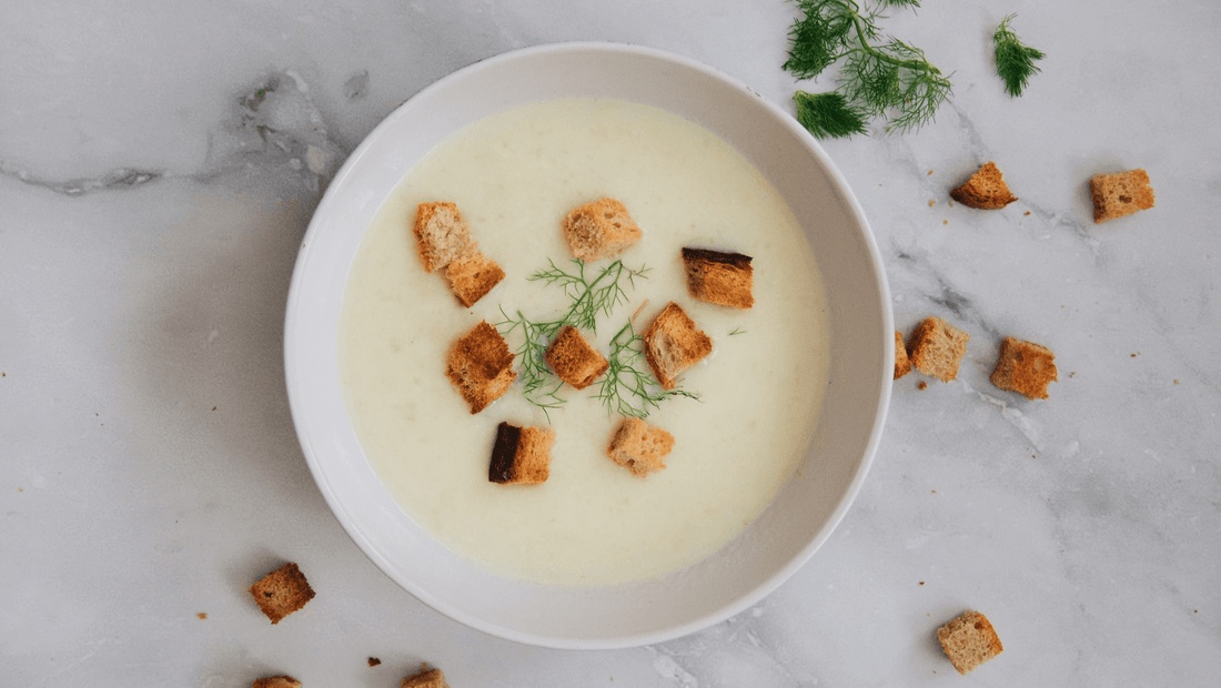 Bowl of creamy vegetable soup topped with croutons and fresh herbs, made with organic vegetables and organic food delivery in Brisbane