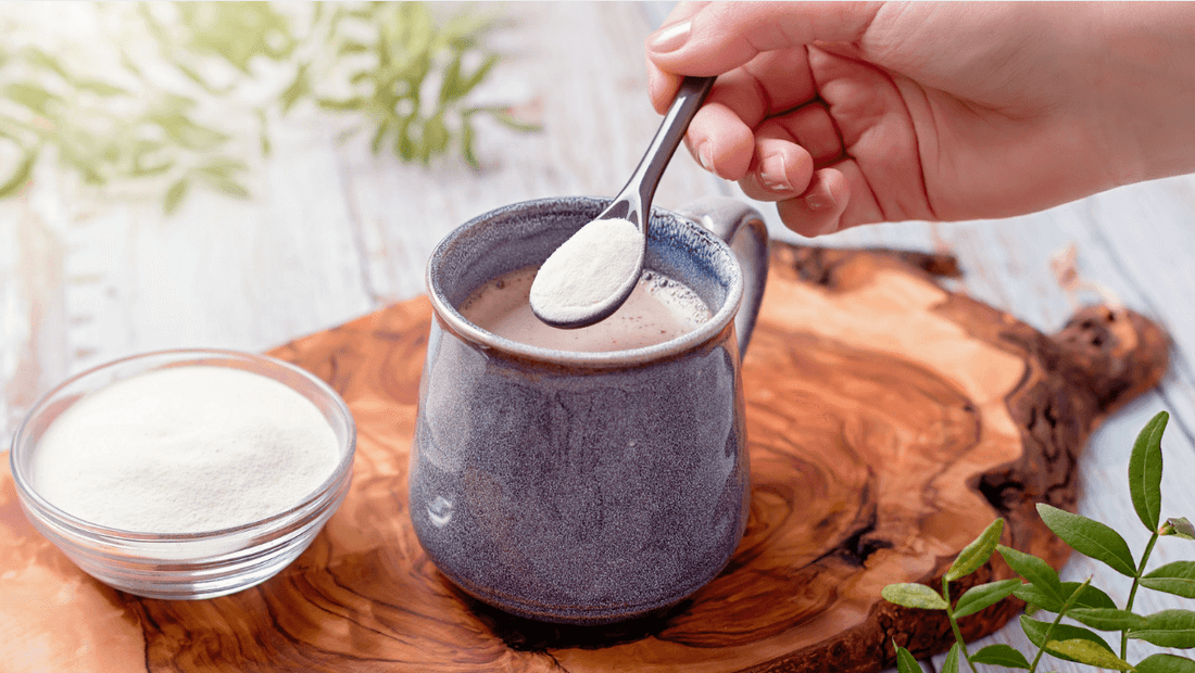 Person adding grass-fed collagen peptides to morning coffee.