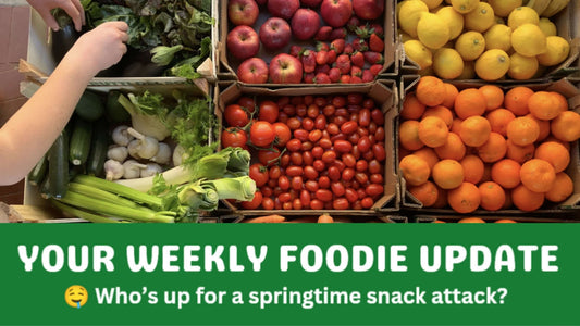 Fresh organic fruit and vegetables in crates, including leafy greens, apples, tomatoes and citrus, representing organic fruit and veg delivery in Brisbane.
