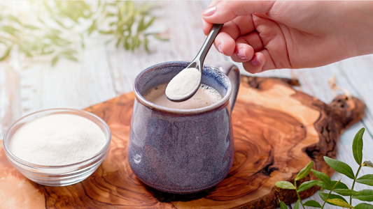 Person adding grass-fed collagen peptides to morning coffee.